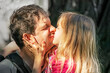 © Nataliia Makarovska - little girl daughter with long blond hair hugs and kisses dad. Father's Day. Family holiday