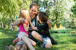 © Nataliia Makarovska - happy dad plays with children a girl and a boy in nature. Family holiday