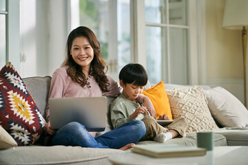 Wall Mural - home portrait of young asian mother and five-year-old son