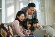 © imtmphoto - happy young asian family with two children using notebook computer together