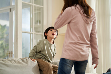 Wall Mural - young asian mother and son having a bad time at home