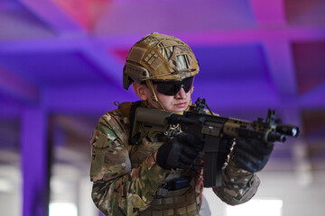 Wall Mural - A professional soldier undertakes a perilous mission in an abandoned building illuminated by neon blue and purple lights