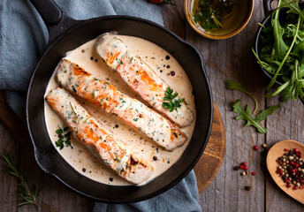 Wall Mural - Cooked salmon fish with cream sauce in frying pan