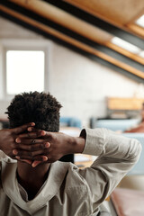 Aufkleber - Rear view of young businessman keeping clasped hands behind his head while thinking, trying to concentrate or just relaxing for a while