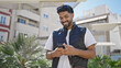 © Krakenimages.com - African american man smiling confident using smartphone at park