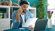© Krakenimages.com - African american man talking on smartphone reading document at dinning room