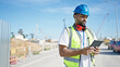 © Krakenimages.com - African american man builder using touchpad at street