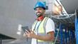 © Krakenimages.com - African american man builder smiling confident using touchpad at street