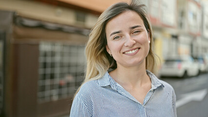 Wall Mural - Young blonde woman smiling confident standing at coffee shop terrace