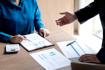 Poster - businessman executive is pointing with his hand for businesswoman