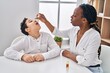 © Krakenimages.com - African american mother and son having nose treatment at home