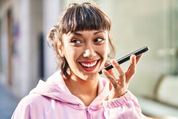 Sticker - Young woman smiling confident talking on the smartphone at street