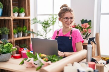 Sticker - Young blonde woman florist smiling confident using laptop at flower shop