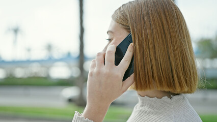 Sticker - Young blonde woman talking on smartphone at street