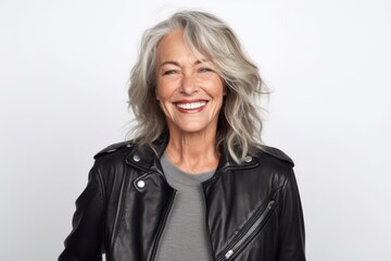 Portrait of happy senior woman in leather jacket smiling at camera.