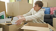 © Krakenimages.com - Young caucasian man packing cardboard box at new home