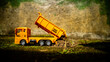 © 42L - South Minahasa, Indonesia : January 2023, a yellow dump truck toy transporting sand