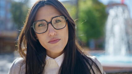 Sticker - Young beautiful hispanic woman standing with serious expression at park