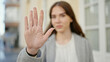 © Krakenimages.com - Young hispanic woman doing stop gesture with hand at street