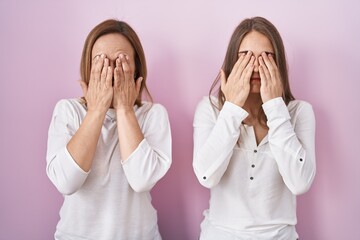 Poster - Middle age mother and young daughter standing over pink background rubbing eyes for fatigue and headache, sleepy and tired expression. vision problem