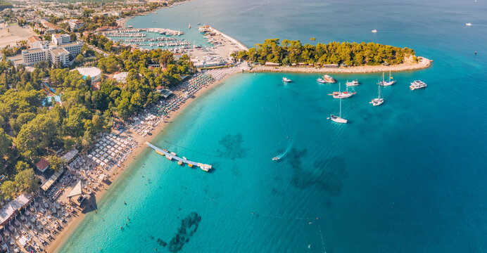 aerial paradise view, showcasing an idyllic harbor adorned with luxurious yachts and green forest in Kemer, Turkey