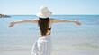 © Krakenimages.com - Young chinese woman tourist wearing swimsuit and summer hat at seaside