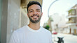© Krakenimages.com - Young hispanic man smiling confident standing at street