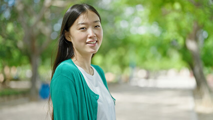 Poster - Young chinese woman smiling confident standing at park