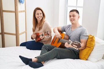 Poster - Man and woman mother and son playing classical guitar and ukulele at bedroom