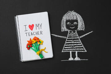 Wall Mural - A girl with flowers is drawn on a black school board