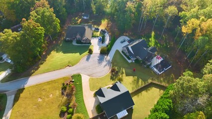 Wall Mural - View from above of expensive residential houses between yellow fall trees in suburban area in South Carolina. American dream homes as example of real estate development in US suburbs