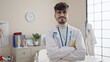 © Krakenimages.com - Young hispanic man doctor smiling confident standing with crossed arms at clinic