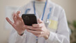© Krakenimages.com - Young hispanic man doctor using smartphone at clinic