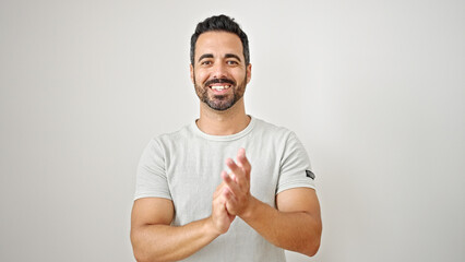 Wall Mural - Young hispanic man smiling confident clapping hands over isolated white background