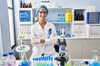 © Krakenimages.com - Brunette woman working at scientist laboratory happy face smiling with crossed arms looking at the camera. positive person.