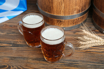 Mugs of cold beer on wooden background. Oktoberfest celebration