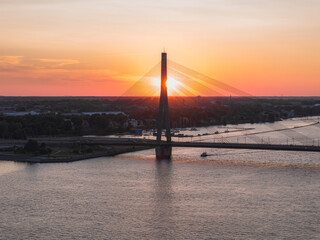 Wall Mural - Aerial view of the suspension bridge in Riga, Latvia at sunset. Beautiful architecture in Latvia.