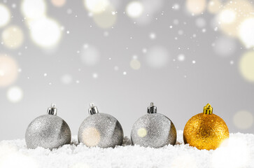 Canvas Print - silver and golden decorative christmas balls on snow against grey festive background