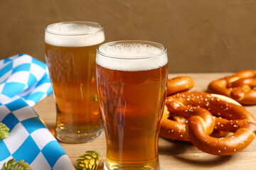 Flag of Bavaria, mugs with beer and pretzels on wooden table