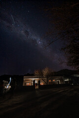 Wall Mural - The Milky Way Galaxy moving over the mountain ridge. Night lapse from night to day. Starry night.