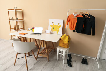 Wall Mural - Stylish interior of children's room with modern laptop and school uniform