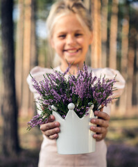 Sticker - Beautiful girl in the forest holding in a vase with heather. Forest.