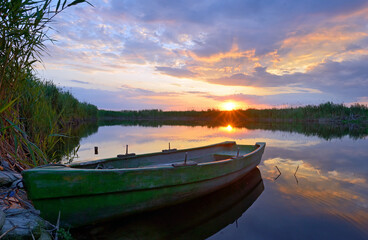 Naklejka na meble Fisherman boat on Danube Delta at sunset