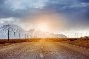 Wall Mural - Straight road goes to horizon and mountains