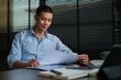© wattana - Concentrated businessman reading contract, partnership agreement and working in modern office.