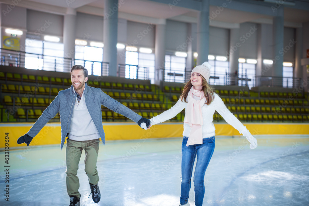 Smiling young couple at skating rink Stock Photo | Adobe Stock