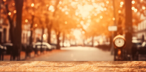 Empty wooden table top against the backdrop of an autumn cityscape, city street with orange foliage garlands of lights