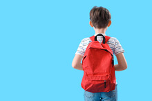 Little Boy With Schoolbag On Blue Background, Back View