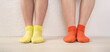 © Kana Design Image - legs and socks of two girls standing in front of a white wall indoors. 屋内の白い壁の前に立っている女の子の脚と靴下