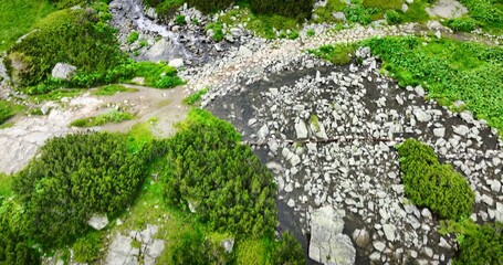 Wall Mural - waterfall in the mountains, water flowing on the mountain hills, nature of bulgaria. rila lakes 4k a